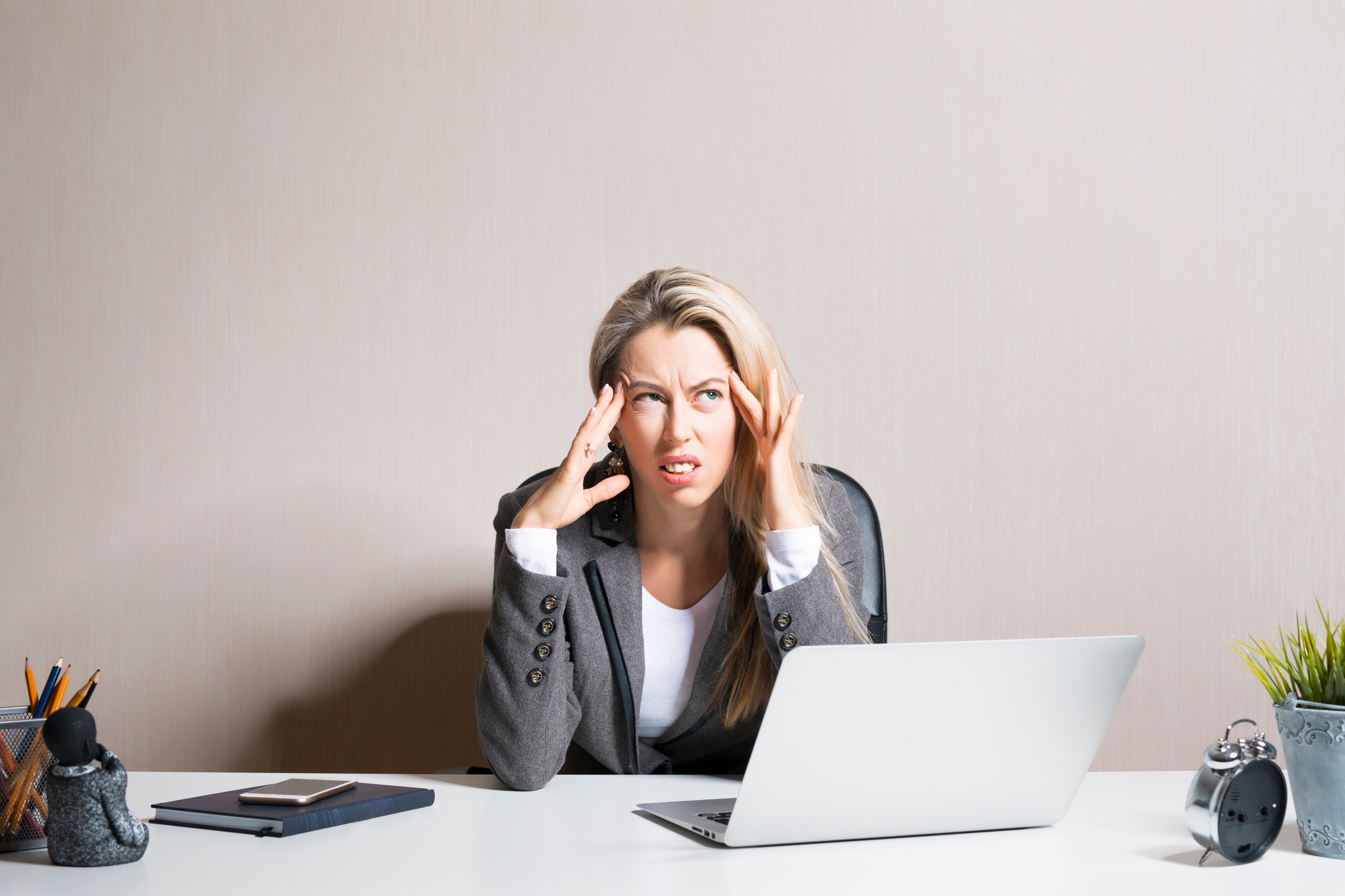 Stressed and Exhausted Woman Sitting at Office Desk